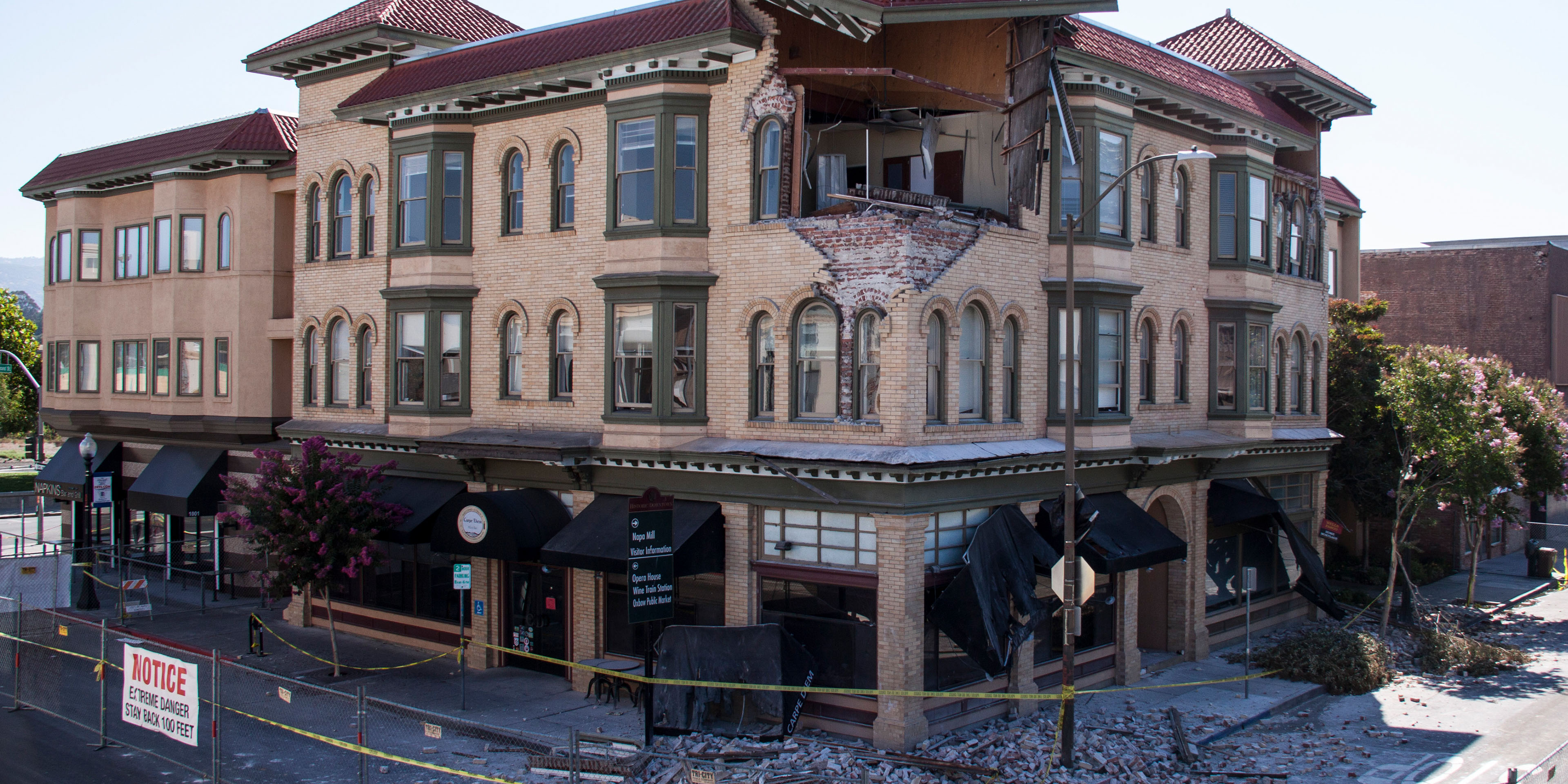 Building with collapsed roof and missing wall after an earthquake