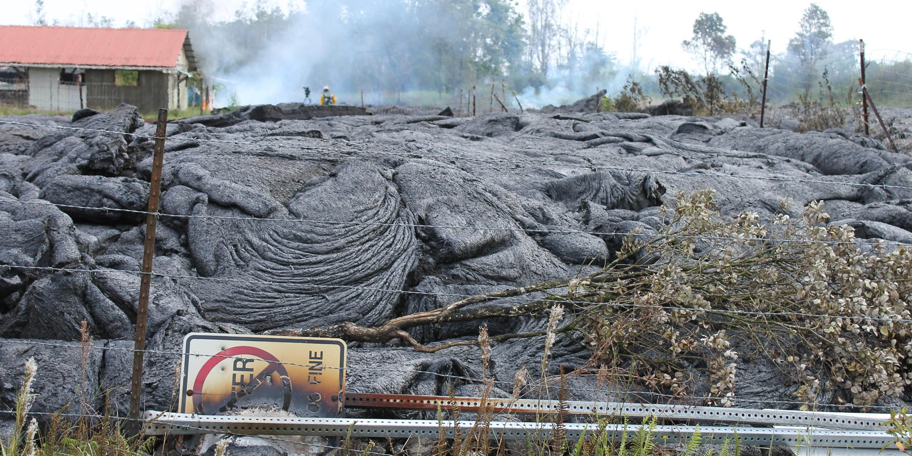 Area of cooling lava flows and burned 'No Litter' sign.